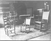 SA0461 - Various types of chairs shown, including rockers, a ladder back, and highchair. Photograph is associated with the South Family. Identified on the back., Winterthur Shaker Photograph and Post Card Collection 1851 to 1921c